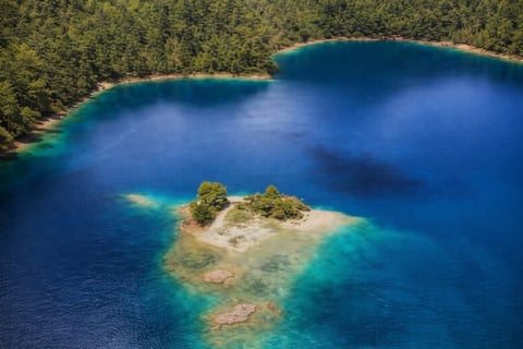 Aerial view of rocky island surrounded by turquoise waters