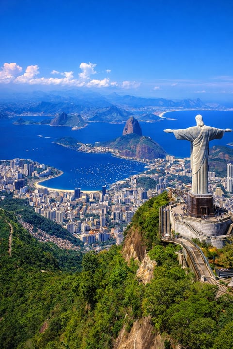 Christ the Redeemer statue overlooking Rio de Janeiro with Guanabara Bay, mountains, and city skyline below
